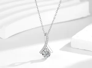 Close-up of mermaid tail pendant necklace with sparkling cubic zirconia solitaire.