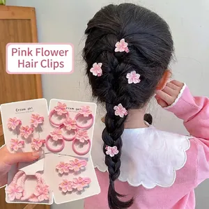 Close-up detail of sweet pink flower hair clips and elastic hair ties for girls