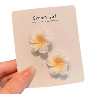 Sweet white frangipani flower hair clips on display card for baby and kids hair styling