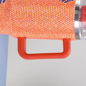 Detail of a 40oz orange rhinestone tumbler with a sturdy red handle for secure grip.