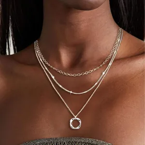 Elegant three-layer silver layered necklace featuring snake chain and circle pendant design