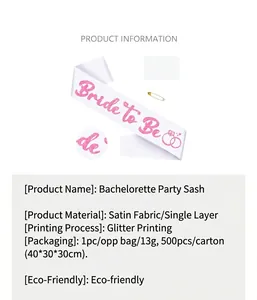 Detailed macro view of white satin sash featuring pink glitter Bride to Be text and safety pin