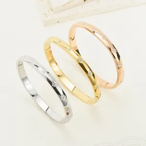 Set of titanium steel bangles with rhinestone star pattern in silver, gold and rose gold finish