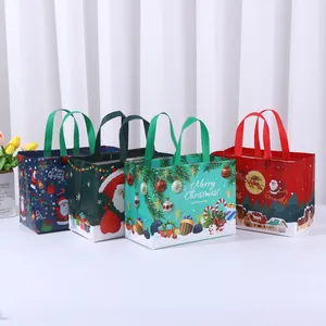 Set of four colorful laminated non-woven Christmas gift bags with festive patterns