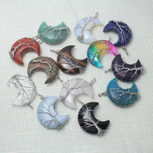 Collection of wire-wrapped tree of life crescent moon crystal pendants in various colors