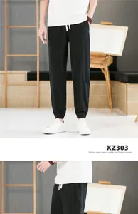 Pantalon de jogging pour homme en coton et lin noir avec cordon de serrage et poignets.