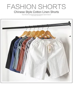 Detail view of men's cotton linen shorts in various colors hanging on a rack