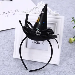 Detail view of black Halloween witch hat headband with sparkly buckle and star patterns.