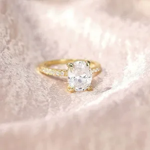 Detail view of an elegant 3ct oval zircon engagement ring in gold-plated silver setting.