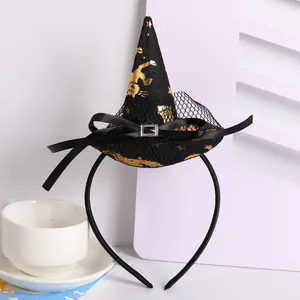 Macro view of a black Halloween witch hat headband with gold cat and star foil prints