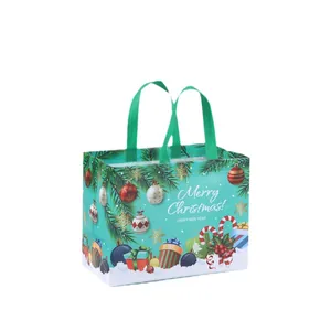 Durable non-woven Christmas gift bag with festive holiday patterns and green handles