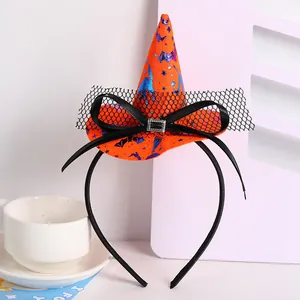 Close-up of Halloween witch hat headband with orange fabric, mesh veil and black bow detail