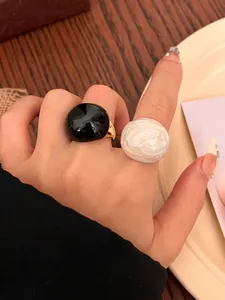 Detailed shot of vintage round egg-shell rings in black and pearly white finish