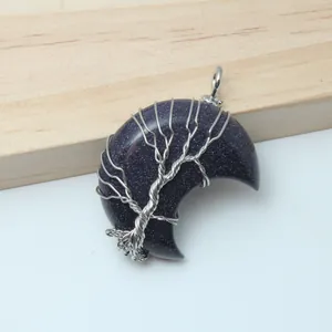 Detailed view of wire wrapped tree of life on a blue sandstone crescent moon pendant