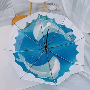 Automatic clear folding umbrella featuring a refreshing blue dolphin ocean print