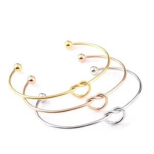 Three-piece set of knot design open bangles in gold rose gold and silver finish