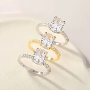 Elegant silver and gold oval zircon rings featuring 3 carat pigeon egg center stones