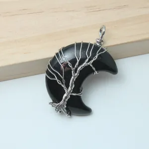 Detailed view of handcrafted silver wire-wrapped black crescent moon Tree of Life pendant jewelry