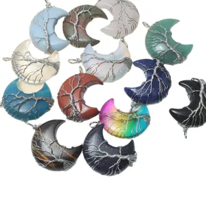 Selection of natural crystal crescent moon pendants with hand-wrapped tree of life design