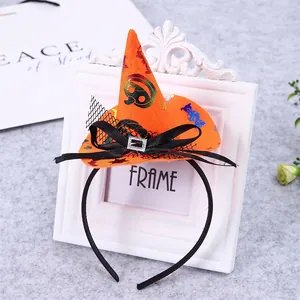 Detailed view of Halloween witch hat headband with orange pumpkin patterns and mesh