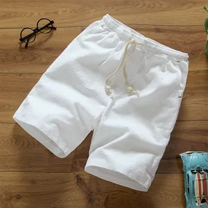 Men's white cotton linen summer shorts with drawstring waist on wooden background