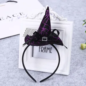 Close-up of Halloween witch hat headband featuring purple spiderweb pattern and mesh bow