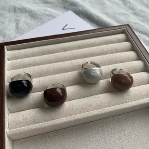 Detailed view of vintage enamel eggshell open rings in chocolate and caramel hues