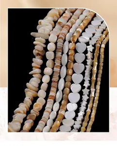 Close-up of various natural shell beads in heart, star, and bamboo shapes for jewelry making.
