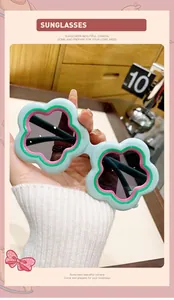 Close-up of mint green flower-shaped children's sunglasses with colorful accents