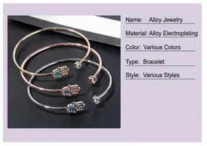 Detail of three Hamsa hand open bangles in gold, rose gold and silver finish