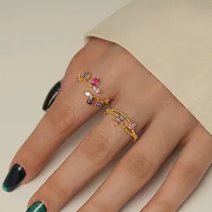 Detailed macro view of an adjustable gold-plated silver floral ring with colorful gems