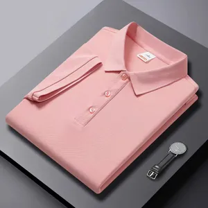 Close-up of a neatly folded men's pink polo shirt with high-quality pique fabric.