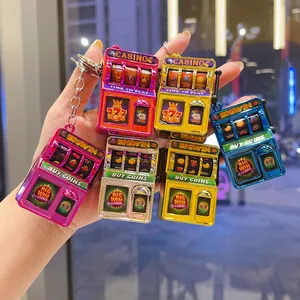 Mini electroplated slot machine keychains in assorted vibrant colors for stress relief