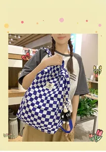 Detailed shot of a stylish blue and white checkered backpack worn by a model in a shop