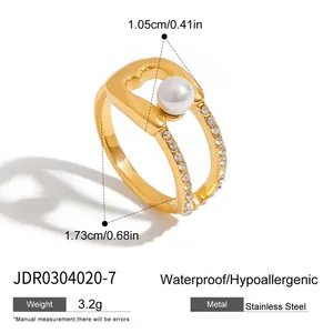 Detailed view of gold stainless steel paperclip ring with pearl and stones for women