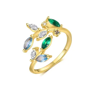 Detailed macro shot of an adjustable leaf-shaped gold ring with multi-color zircons
