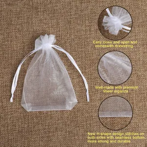 Detailed view of white sheer organza drawstring gift bag showing texture and stitching.