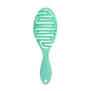 Mint green hollow-out massage hair brush for wet and dry hair detangling and scalp cleaning.