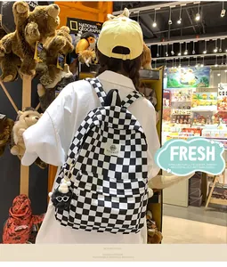 Close-up of trendy black and white checkered backpack in a lifestyle store setting