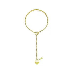 Detail view of golden Cuban Y chain necklace featuring heart sliding ring and lock