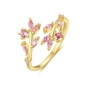 Close-up macro view of gold adjustable ring featuring pink zircon flower design