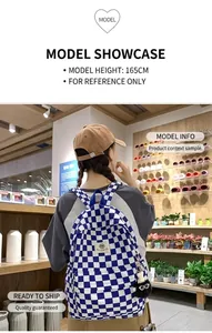 Detailed back view of a blue and white checkered backpack on a model in a lifestyle shop