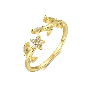 Detailed view of gold-plated silver ring featuring yellow stones and flower motifs.