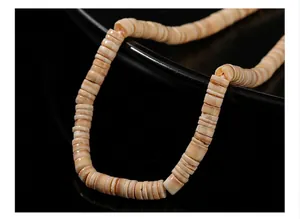 Close-up detail of natural beige bamboo-joint shell beads for making unique jewelry