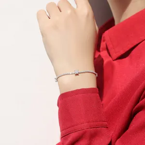 Close-up of a delicate silver bracelet with sparkling stones on a woman's wrist