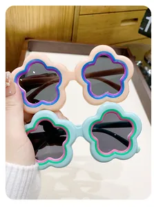 Detail view of two pairs of cute flower-shaped toddler sunglasses in pastel colors