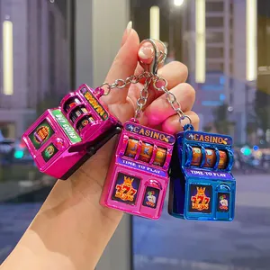 Detailed view of colorful electroplated slot machine keychains with retro casino design