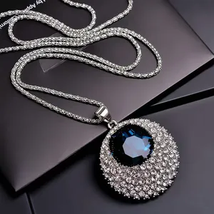 Close-up of sparkling blue crystal pendant on a silver titanium steel long chain