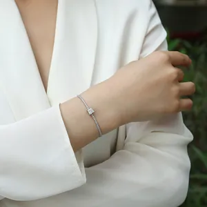 Detailed view of an elegant sterling silver moissanite bracelet on a female model wrist