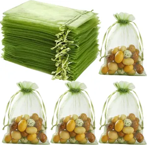 Detailed view of translucent green organza drawstring gift bags with decorative fill
